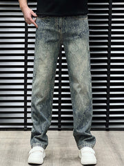 Men's relaxed fit vintage wash jeans in blue cotton with distressed details.