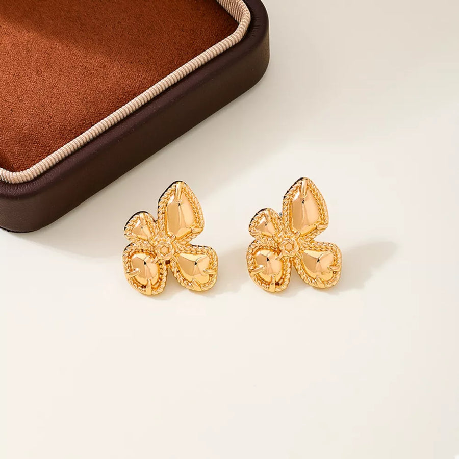 Gold earrings featuring flower design and floral