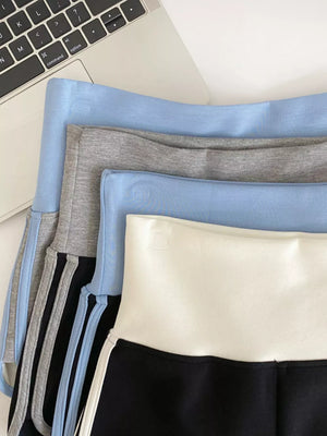 Light blue and gray jogger shorts with contrast trim and side stripes.