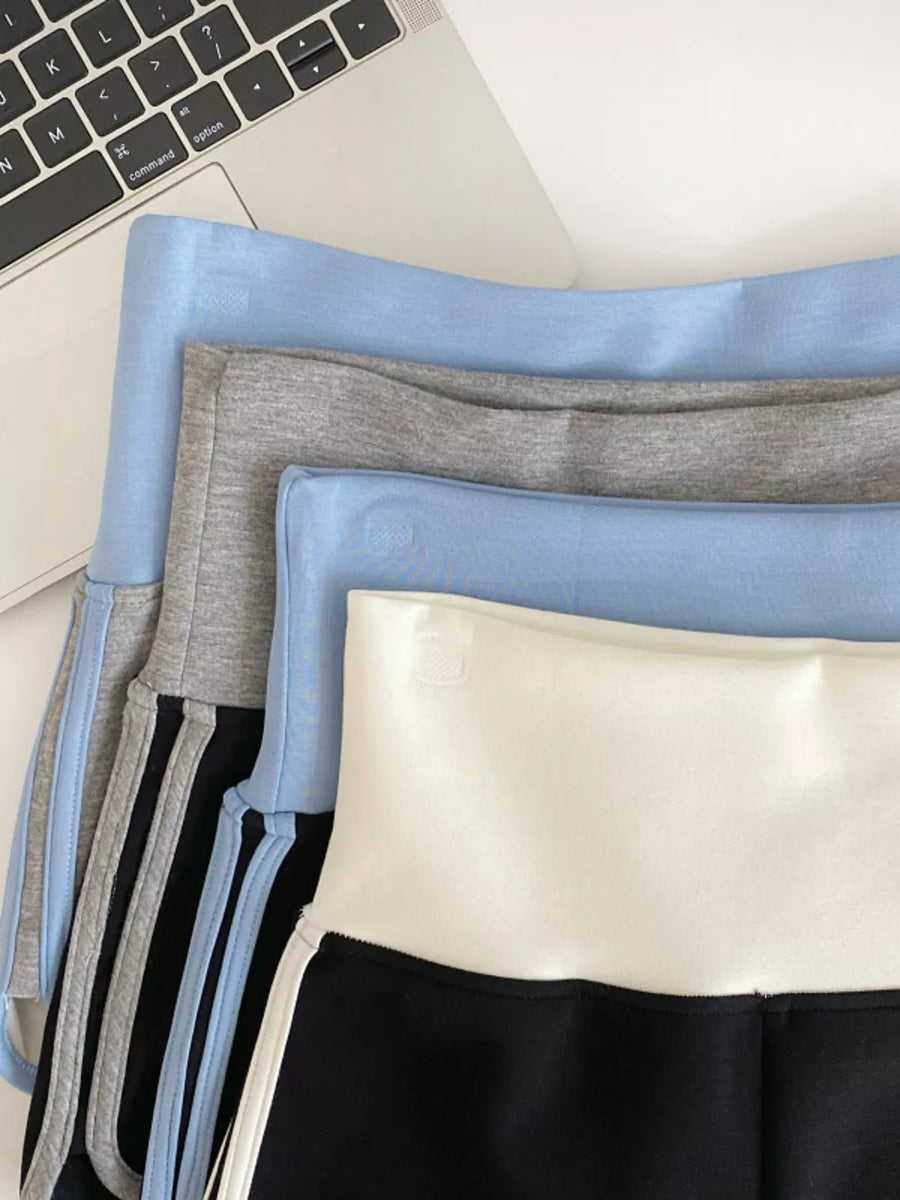 Light blue and gray jogger shorts with contrast trim and side stripes.