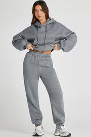 Gray relaxed fit lounge set with hoodie and drawstring pants, featuring a front pocket.