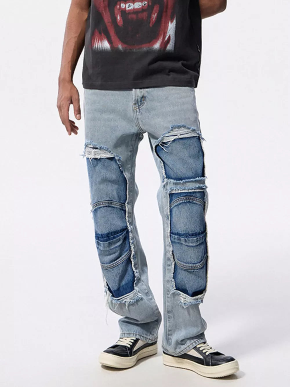 Men's light wash distressed patchwork cotton jeans with raw hems.