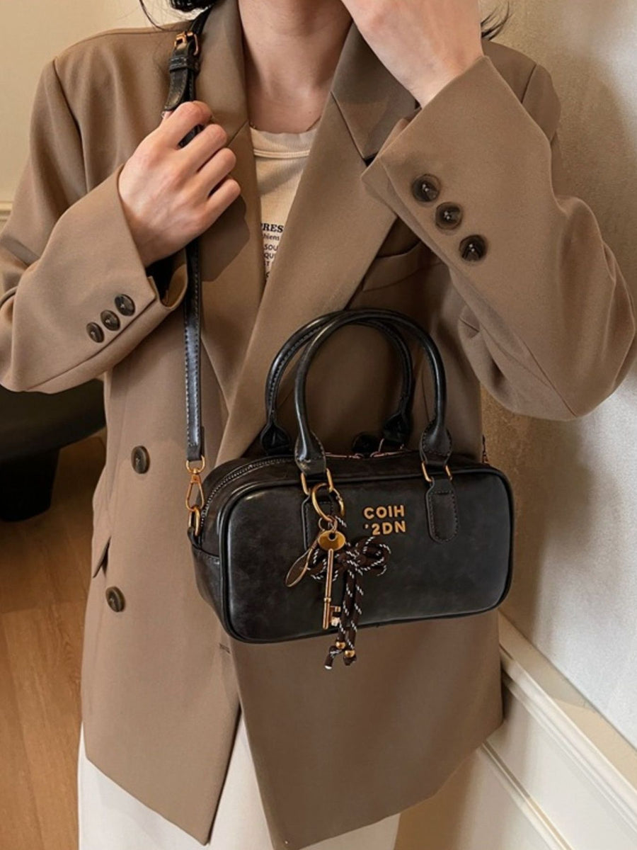 crossbody bag in black featuring adjustable strap and boxy fit