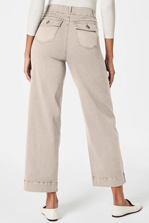 Wide-leg utility denim trousers in Tan with buttoned back pockets and cuffed hems.