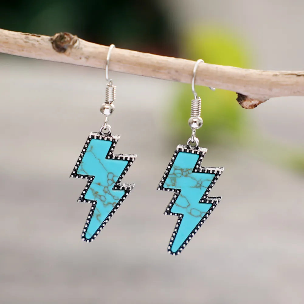 Turquoise bolt drop earrings with silver alloy and artificial turquoise detail.