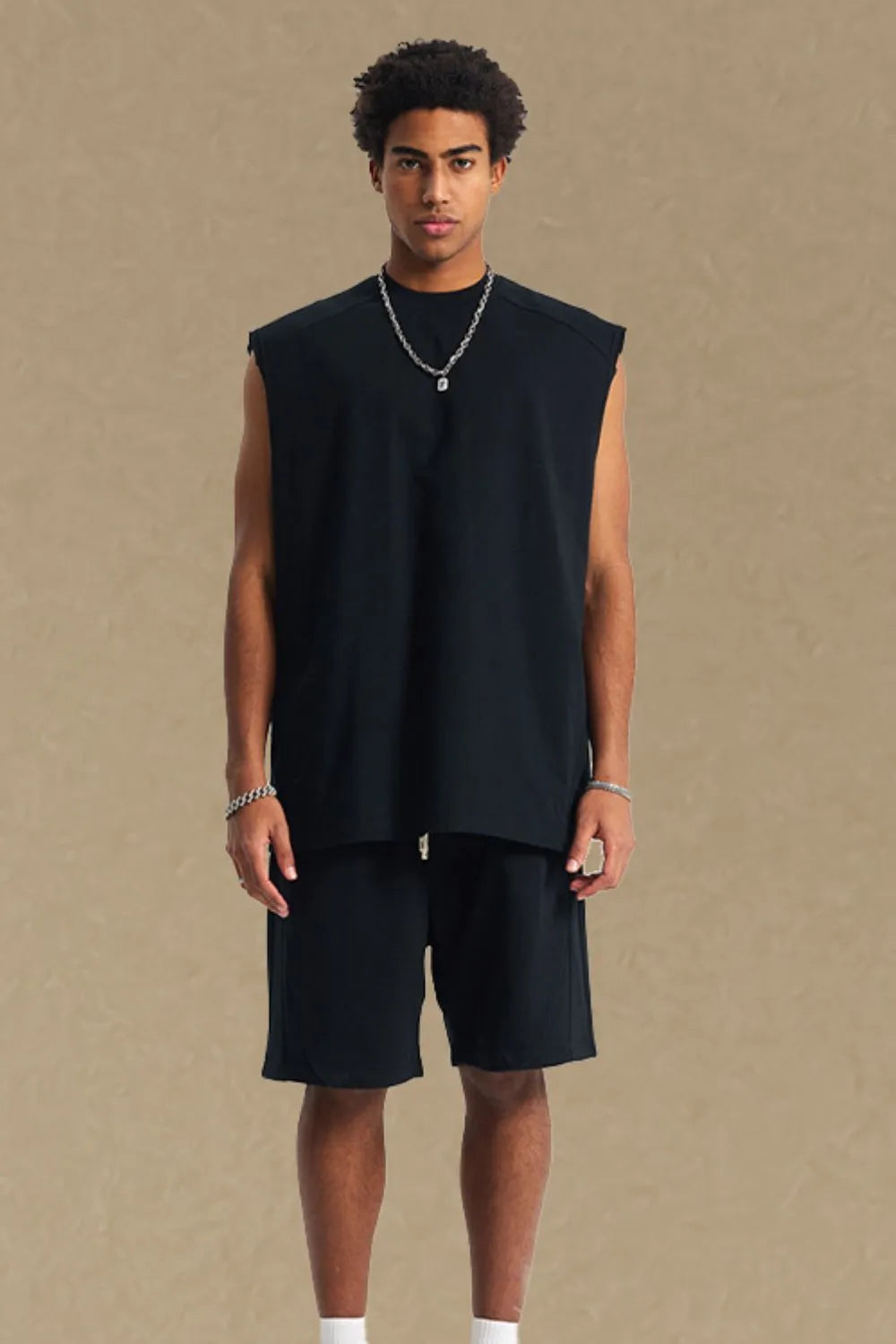 Black boxy shoulder cut tank top with a relaxed fit and crew neck.