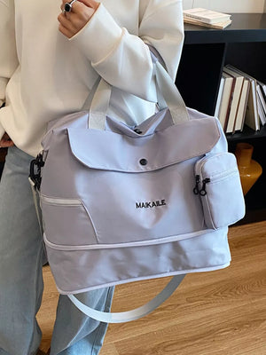Lilac duffel bag with MAIKAILE logo and multiple zippered pockets.