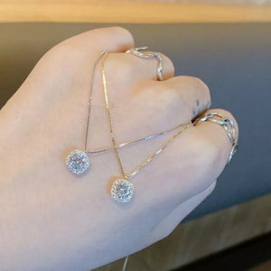 Sterling silver necklaces with zircon pendants in gold and silver tones on a box chain.