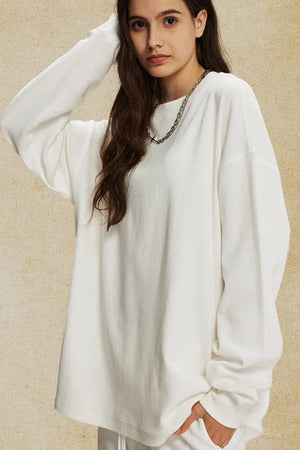 Oversized drop shoulder crewneck sweatshirt in white with a textured knit and crew neckline.