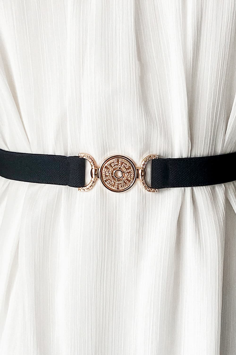 Black elasticated belt with gold medallion buckle detail
