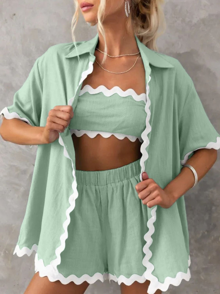 Scalloped edge linen shirt set in gum leaf green with white trim, featuring a button-down shirt, bandeau top, and shorts.