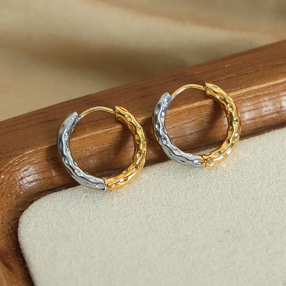 Textured two-tone huggie hoop earrings in gold with hammered finish