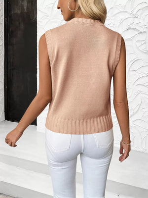 Pink cable knit sweater vest with ribbed hem and neckline.