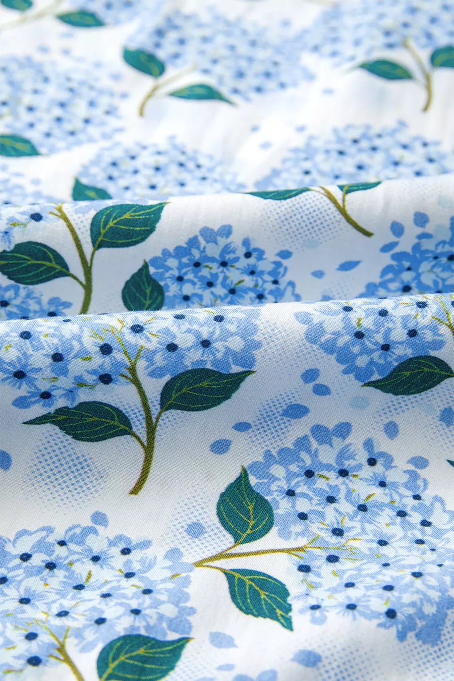 Midi dress with blue hydrangea print on white cotton blend fabric.