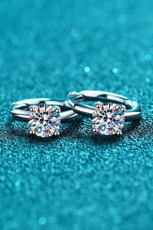 Silver solitaire halo hoop earrings with sparkling round-cut stones.