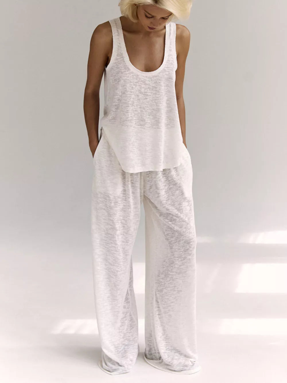 White cropped tank and wide-leg lounge pants set with a scoop neck and relaxed fit.
