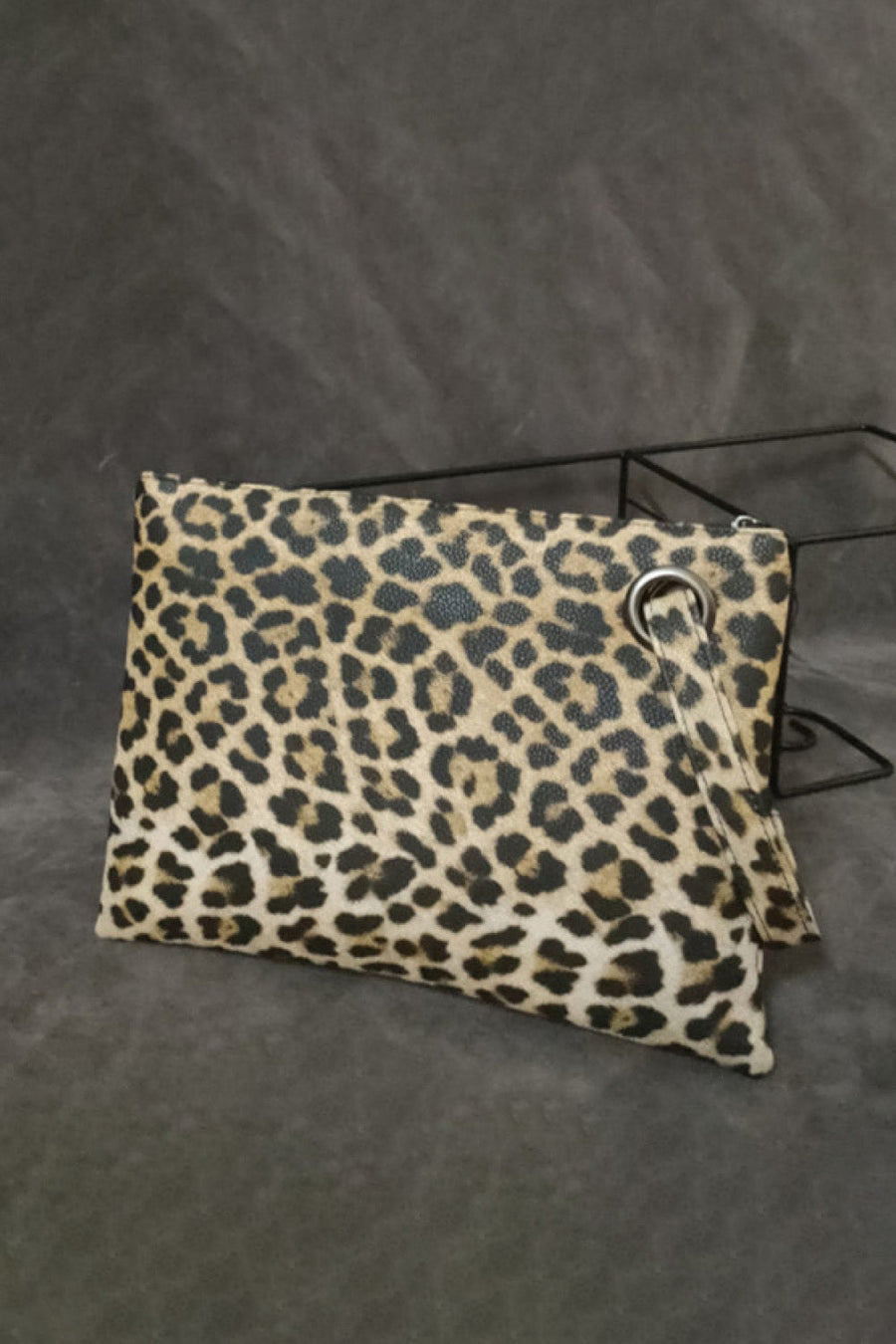 Leopard print zip-top clutch bag with a wrist strap detail