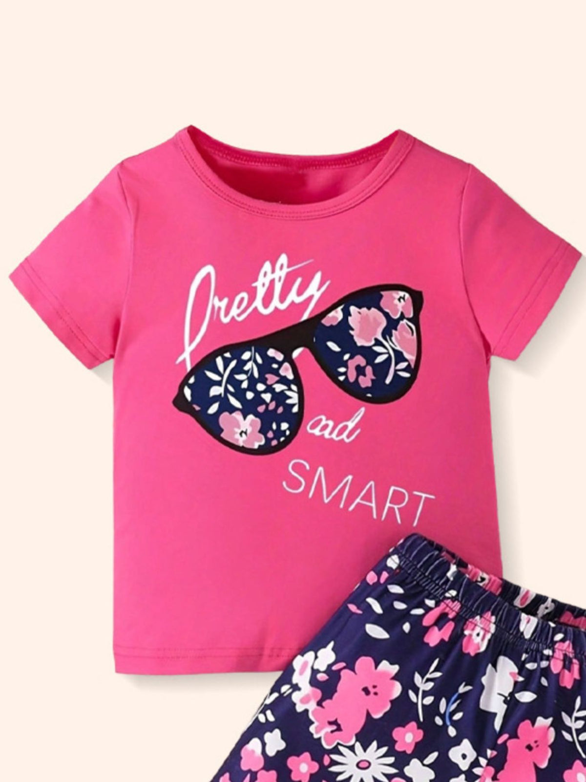 Pink graphic tee with sunglasses and floral shorts set for baby girls.