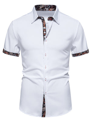 White short sleeve buttoned shirt with paisley trim on collar, cuffs, and placket.