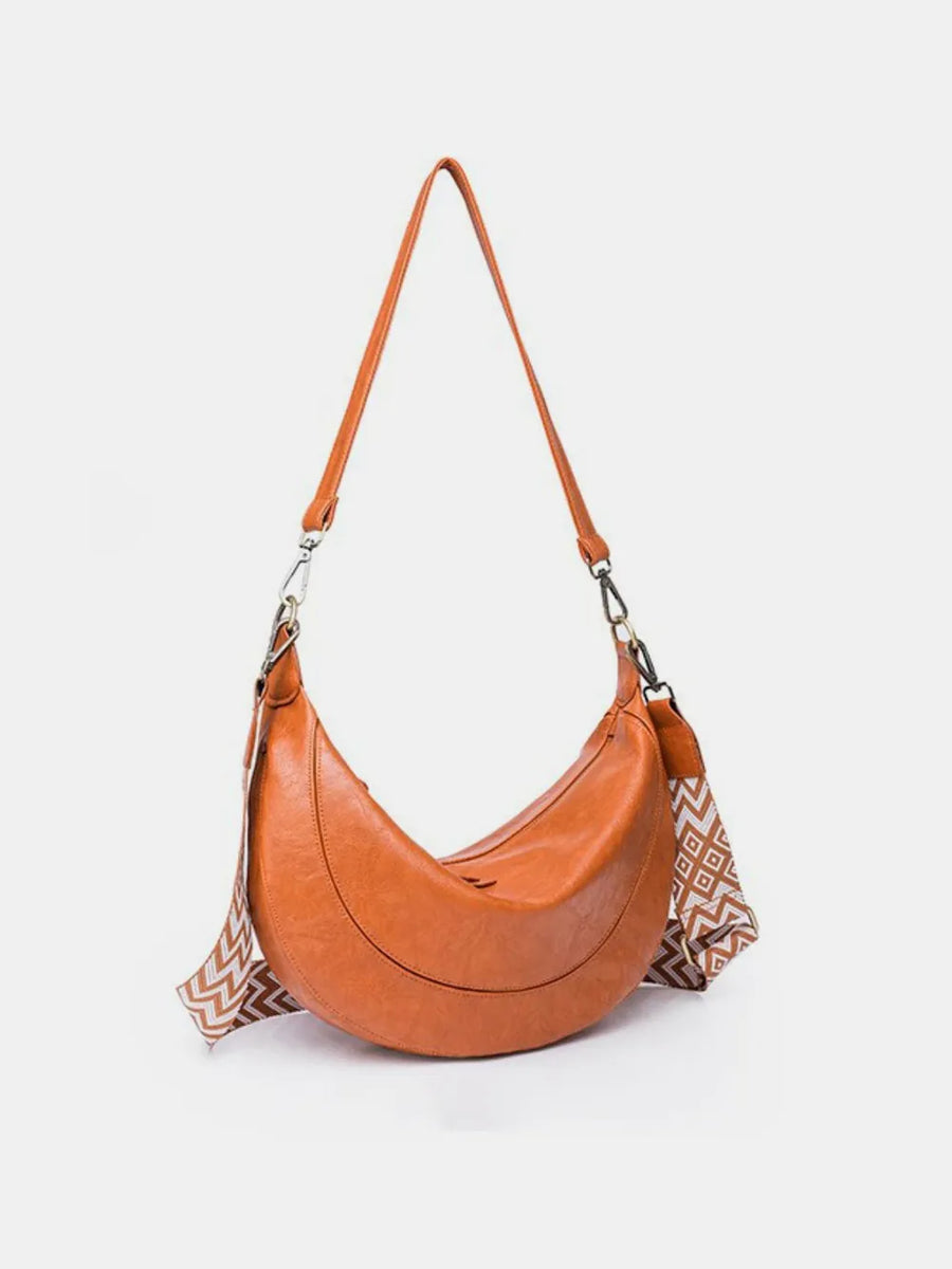 Terracotta leather crescent crossbody bag with geometric strap