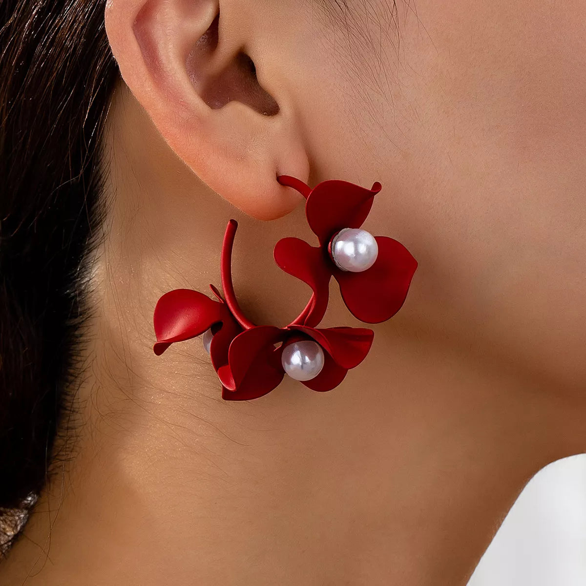 Red floral pearl hoop earrings with matte finish.