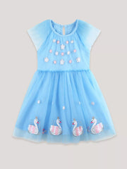 Blue tulle baby dress with cap sleeves, floral embroidery and swan applique hem.