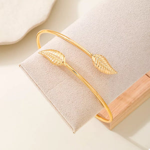 bracelet in gold with leaf and open cuff