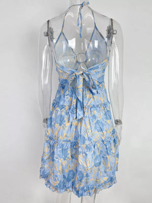Pastel blue halter mini dress with abstract floral print and tiered ruffles.