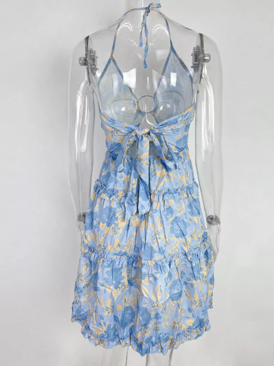 Pastel blue halter mini dress with abstract floral print and tiered ruffles.