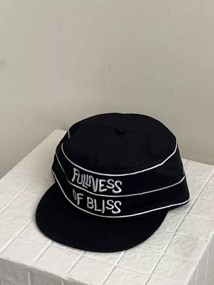 Black cotton baseball cap with embroidered slogan and white piping detail