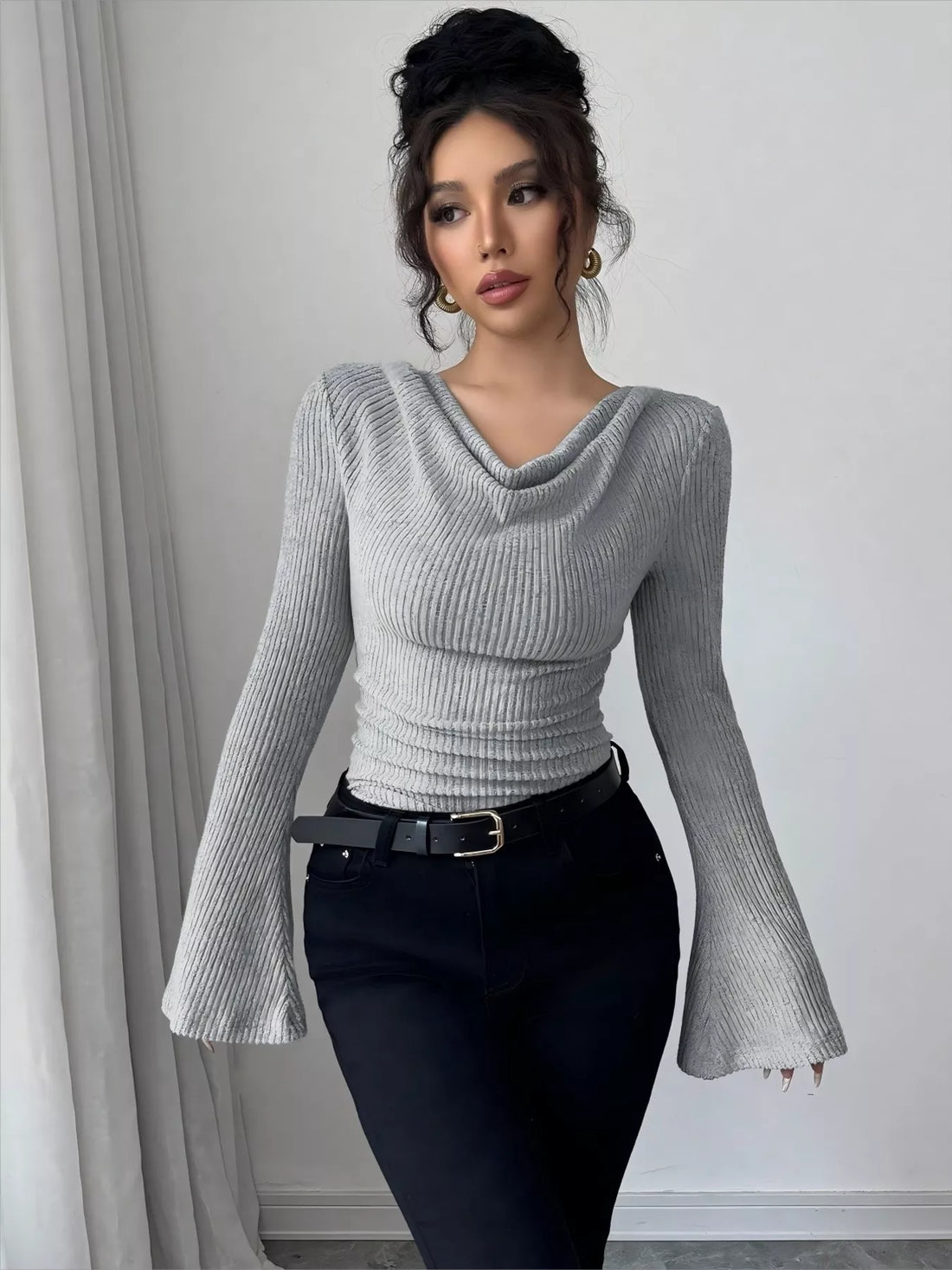 Gray ribbed cowl neck top with bell sleeves and ruched waist detail.