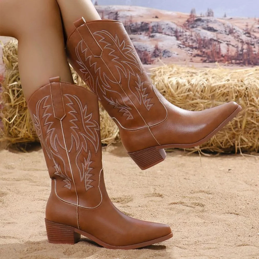 Brown embroidered western-inspired mid-calf boots with block heels and pointed toes.