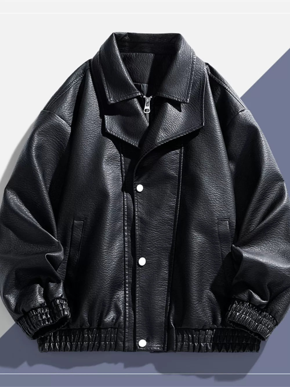 Black faux leather bomber jacket with a zip and snap front, elastic cuffs and hem.