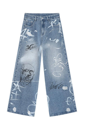 Graffiti art oversized denim trousers in medium wash with distressed details and graphic prints.
