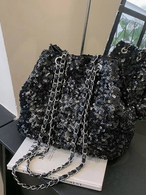 Black sequin bucket bag with chain strap detail