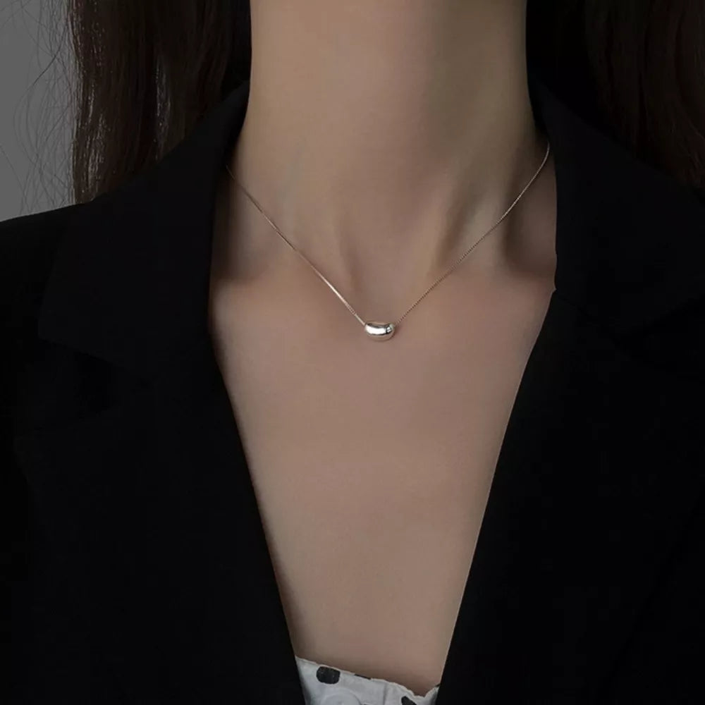 Sterling silver bean pendant necklace with a delicate box chain.