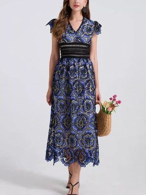 Blue floral lace midi dress with V-neck, cap sleeves, and black waistband.