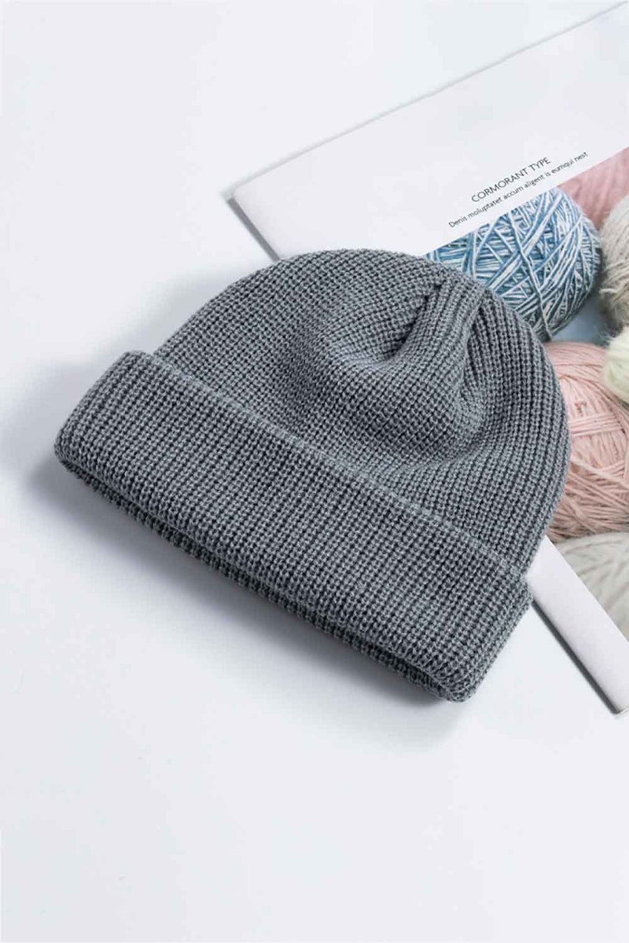 Gray ribbed knit beanie with a turn-up brim.
