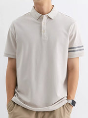 Light gray cotton polo shirt with striped sleeves and a comfortable fit.