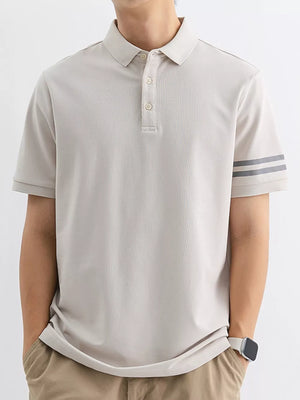 Light gray cotton polo shirt with striped sleeves and a comfortable fit.