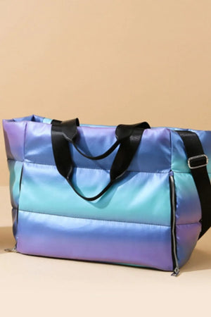 Prismatic padded tote bag in light green and light indigo with black straps and side zips.
