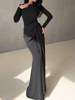 Black ruched long sleeve maxi dress with draped detail and boat neckline.