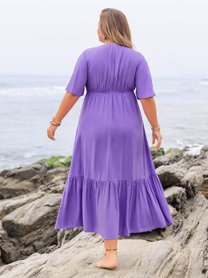 Purple V-neck tiered maxi dress with ruched waist and short sleeves, shown from the back.