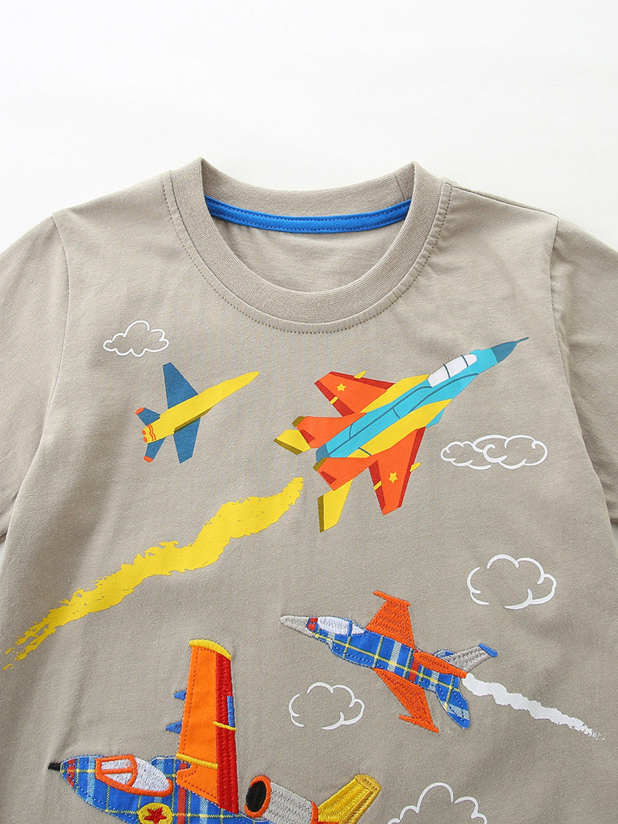 Toddler boys' tan cotton tee with colorful embroidered airplanes and clouds.