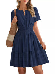 Dark blue textured V-neck tiered dress with smocked waist and short sleeves.