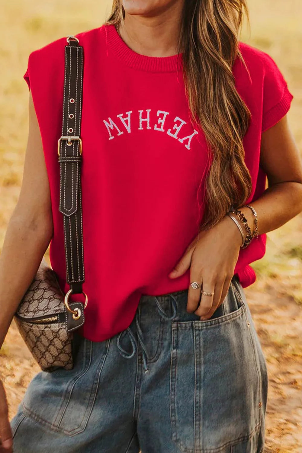 Red crew neck sweater vest with white embroidered "YEEHAW" text, sleeveless, casual style