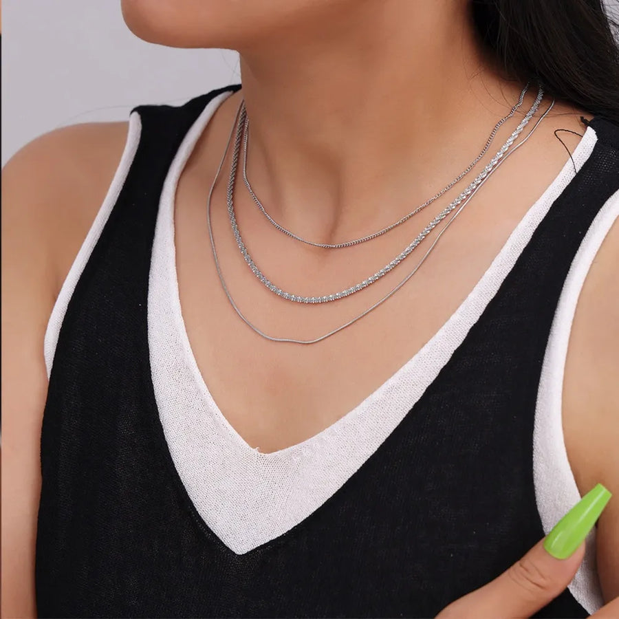 Delicate three-strand silver necklace with crystal accents.