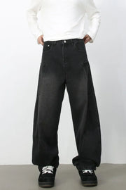 Black denim baggy trousers with a relaxed fit and unique pocket details.
