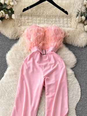 Pink strapless wide-leg jumpsuit with feather trim and belted waist
