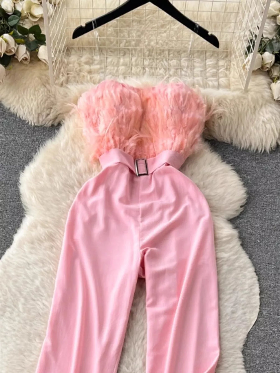 Pink strapless wide-leg jumpsuit with feather trim and belted waist